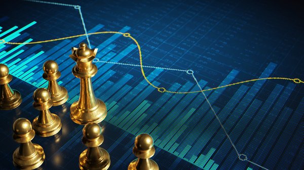 Chess pieces standing on a screen showing financial charts.