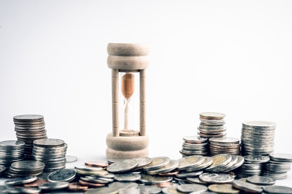 Hourglass surrounded by coins