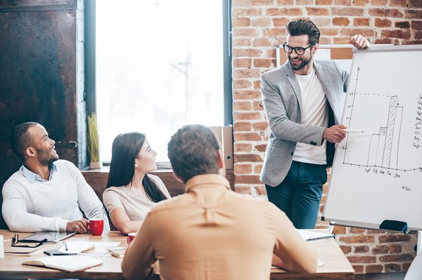 A man presenting data to colleagues in an office