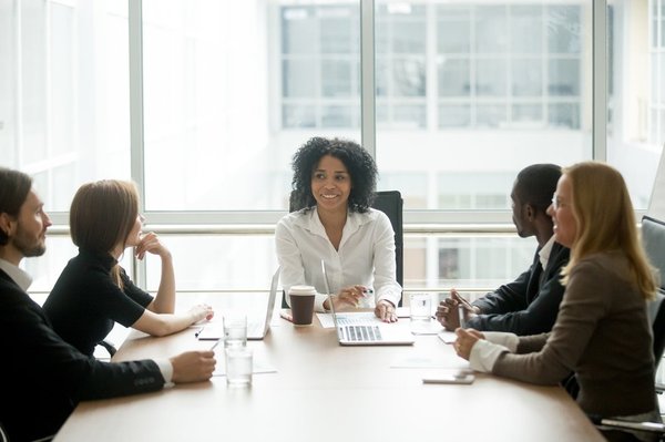 People in an office sitting around a table.