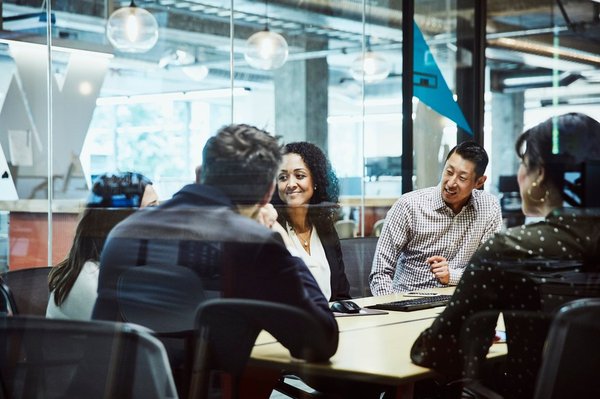 A group of people in an office meeting.