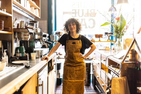 Smiling barista in coffee shop. 