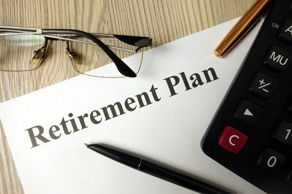 Retirement plan document on a table. Retirement plan.