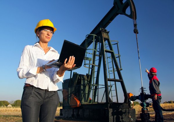 Two engineers work in an oilfield.