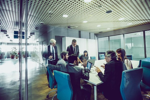 Executives in a conference room to represent a board of directors meeting with an activist investor.