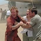 Emotions and tensions run high for passengers of a downed plane lost in the desert, including, left to right: Tony Curran as Rodney, Miranda Otto as Kelly, and Dennis Quaid as Towns.  