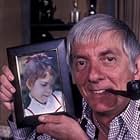 Aaron Spelling at home with a photograph of his daughter Tori Spelling