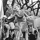 Adored by the people of Argentina, Eva Peron (Madonna, center) uses her position as First Lady to help the masses.