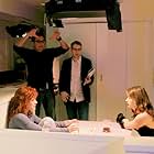 Casey (center) on set Directing a music video with Director of Photography, Art Santamaria (upper left), Actress, Elisa Donovan (left), and Singer, Lisa Donnelly (right).