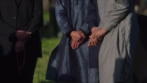 Sinna Mogul in The Undeclared War as the Imam. Funeral Scene, Season 1 - Episode 2.