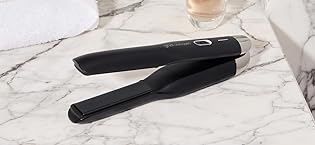 ghd unplugged cordless styler on white granite counter