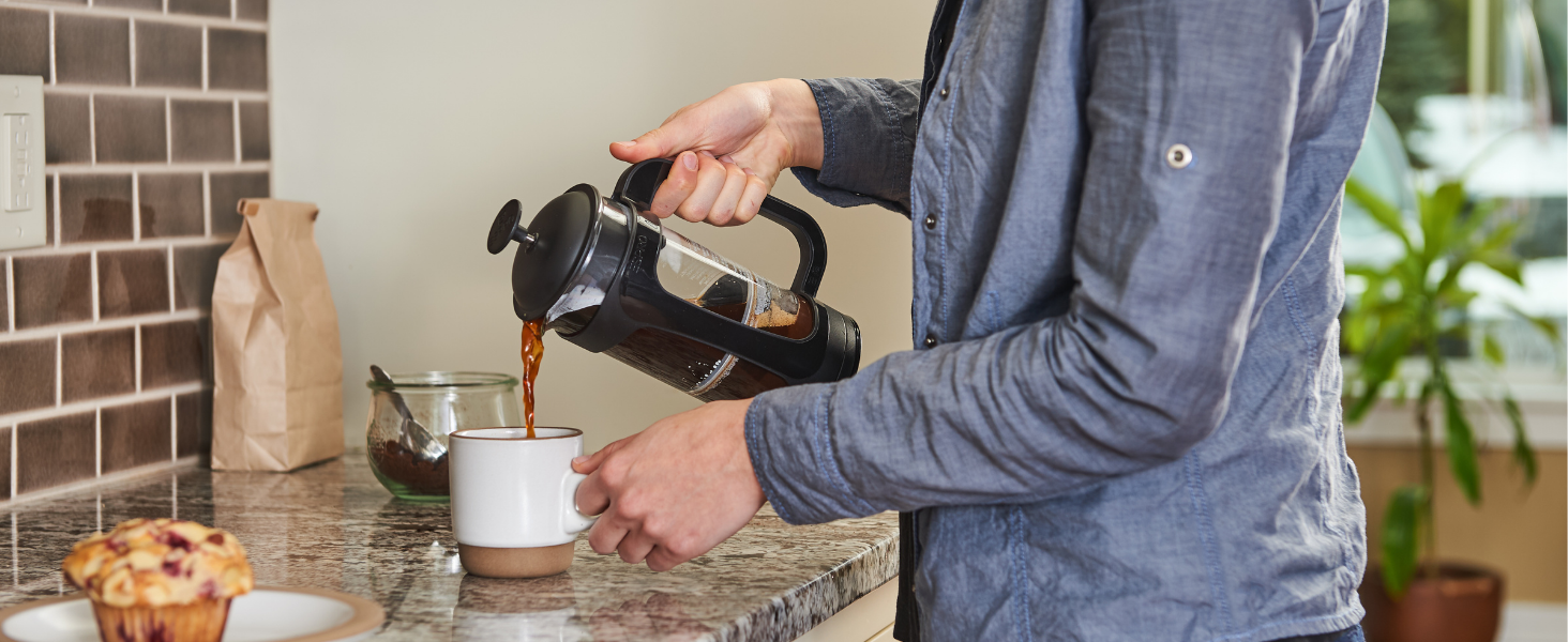 espresso french press pouring hot coffee in kitchen