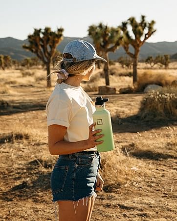 girl holding water bottle in desert