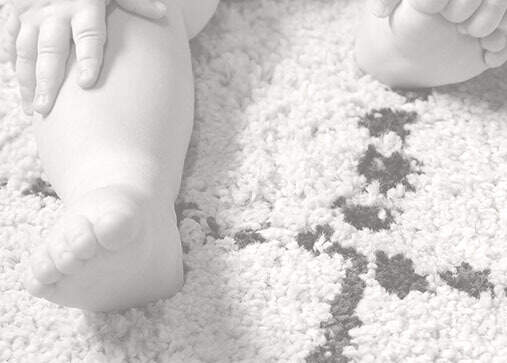 Baby sitting on clean carpet. 