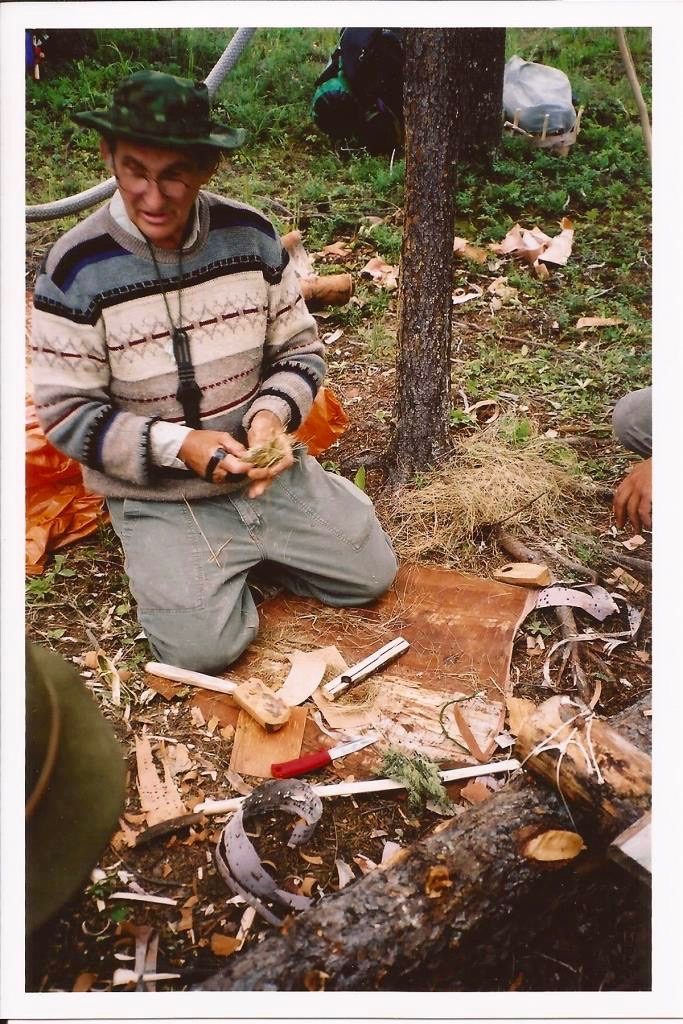 Mors preparing to teach a fire-by-friction class. He uses material from the forest around him and his knowledge of the science behind the process to teach it in a more expedient manner.