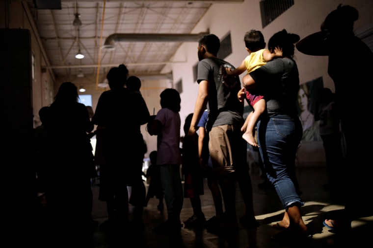 Image: Migrants who returned to Mexico from the U.S. under the Migrant Protection Protocols program line up for food at a migrant shelter in Ciudad Juarez on Sept. 26, 2019.