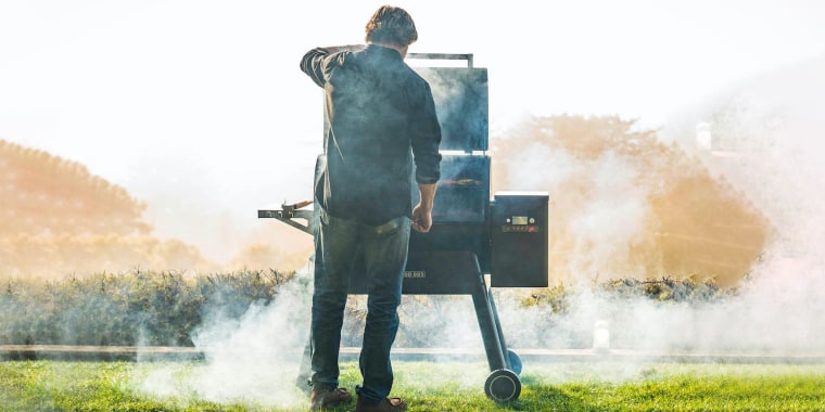 Man standing outside in front of a smoker