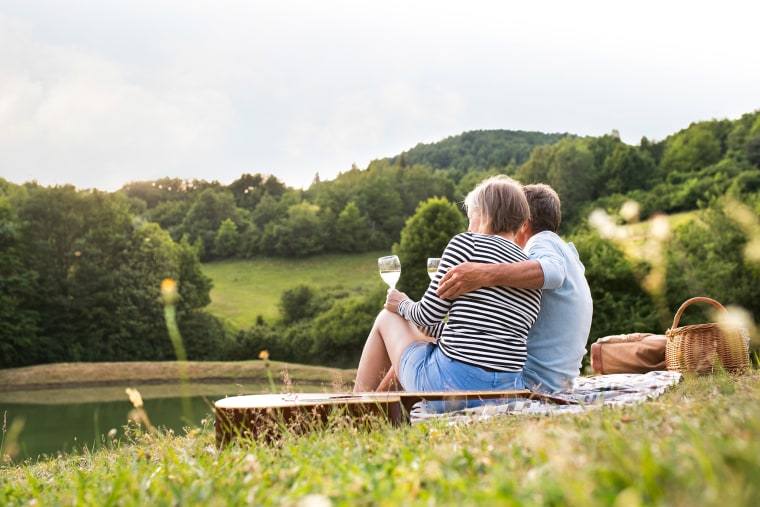 Senior couple at the lake having a picnic