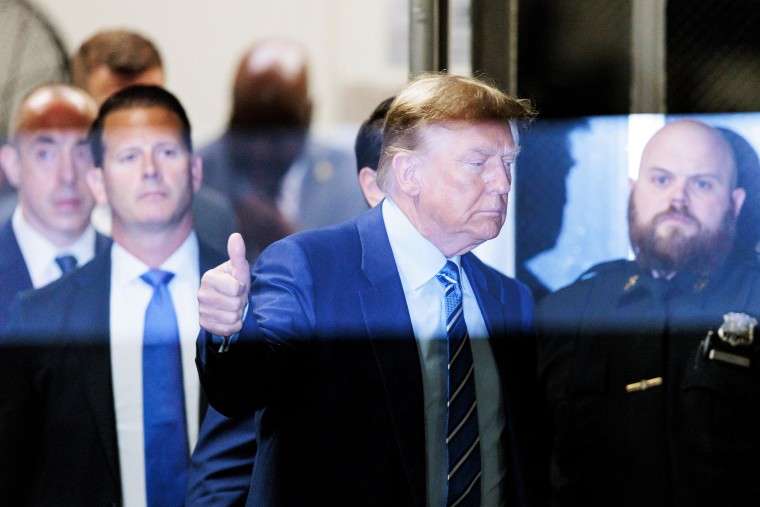 Donald Trump gives the thumbs-up as he returns to the courtroom