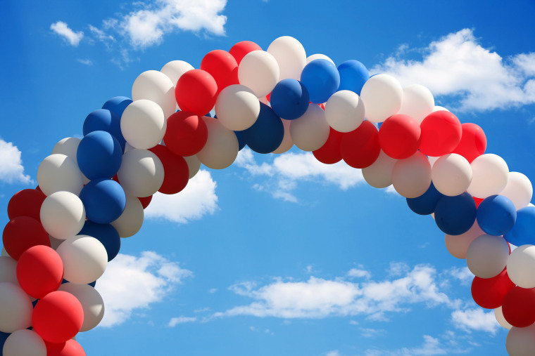 Beautiful blue heavenly and soft cloudy sky with a patriotic balloon arch