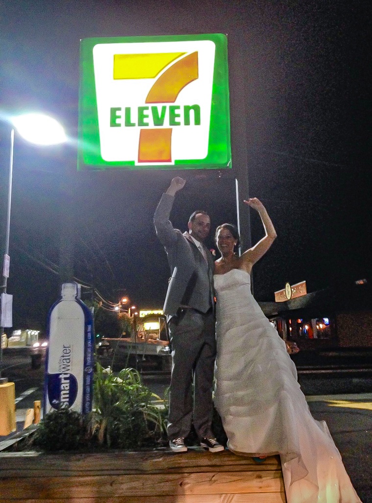 The couple poses for a photo at a 7-Eleven convenience store after their wedding on July 11, 2014. They like that 7/11 is an easy anniversary date to remember.