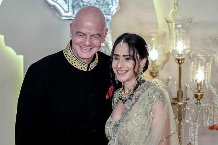 FIFA President Gianni Infantino poses with his wife Leena Al Ashqar for photos as they arrive to attend the wedding ceremony of billionaire tycoon and Chairman of Reliance Industries Mukesh Ambani's son Anant Ambani and Radhika Merchant in Mumbai.