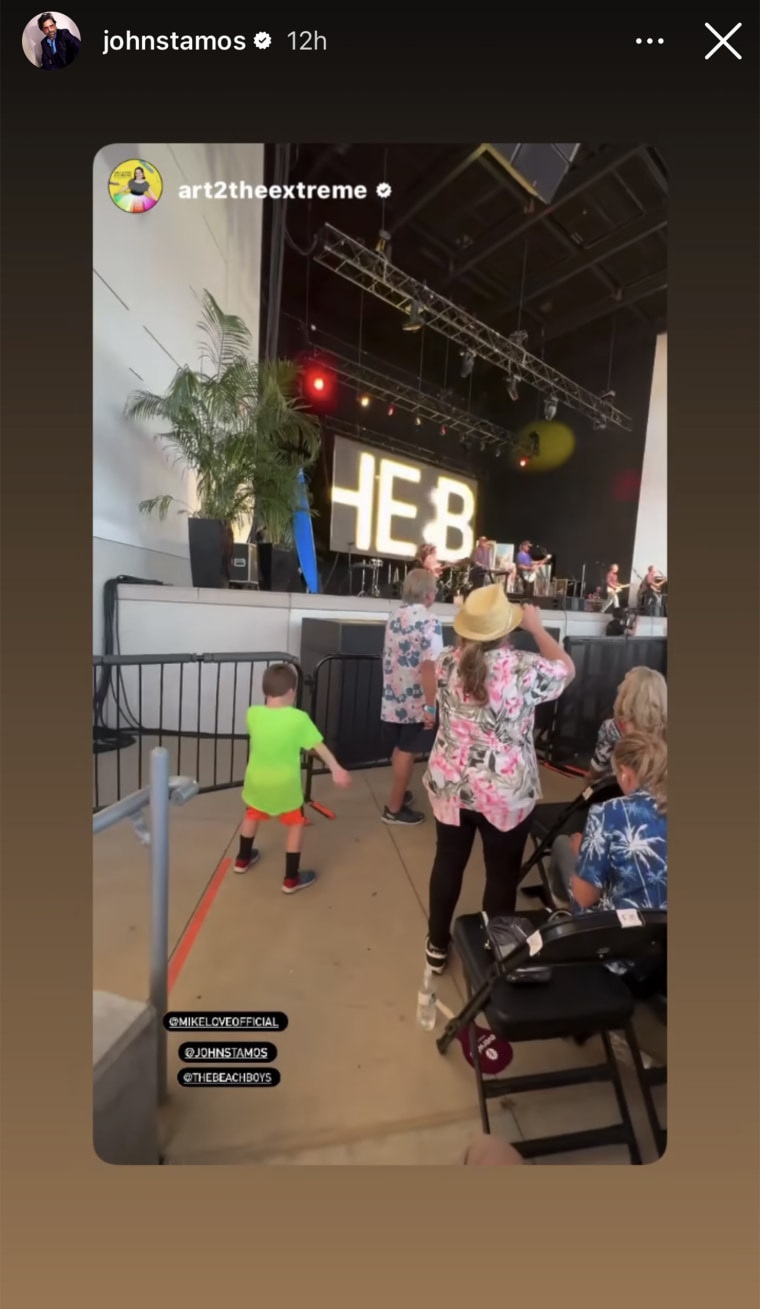 John Stamos' son, Billy, dances in the crowd as The Beach Boys perform. 