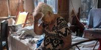 Margarita Salazar wipes sweat off her brow inside her home amid high heat in Veracruz, Mexico