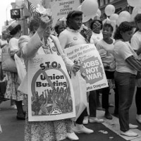 Members of several labor unions demonstrate during the Labor Day parade on 5th Avenue, New York, New York, September 2, 1985. Several carry signs and placards, some of which read 'Stop Busting Unions' and 'Jobs Not War,' while others hold balloons printed with 'Roll Back Imports.'