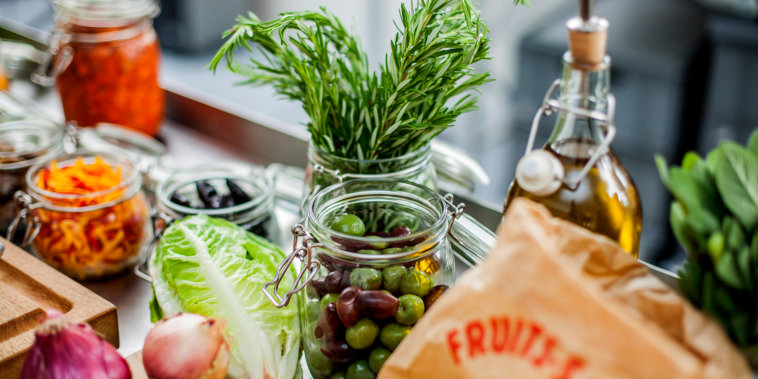 Different ingredients, green olives in glass