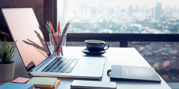 Modern work table with computer laptop and cityscapes view from window.Business concepts ideas