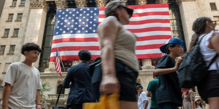 People walk by the New York Stock Exchange on July 5, 2024.