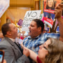 The Rev. Michael Shover of Christ the Redeemer Church in Pella, left, argues with Ryan Maher, of Des Moines as anti-abortion and abortion rights protesters clash in the Iowa Capitol rotunda on July 11, 2023.