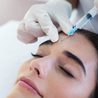 Woman receiving botox injection at spa