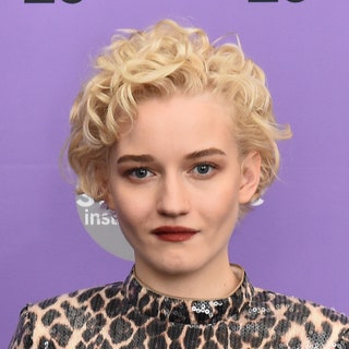 Julia Garner with blonde curly hair