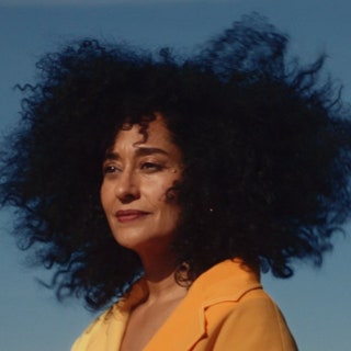 Tracee Ellis Ross posing outside in a yellow blazer