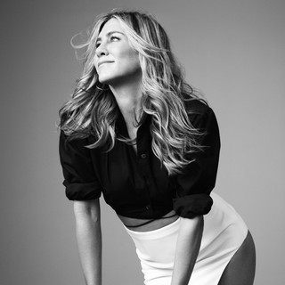 black and white photo of jennifer aniston leaning on stool