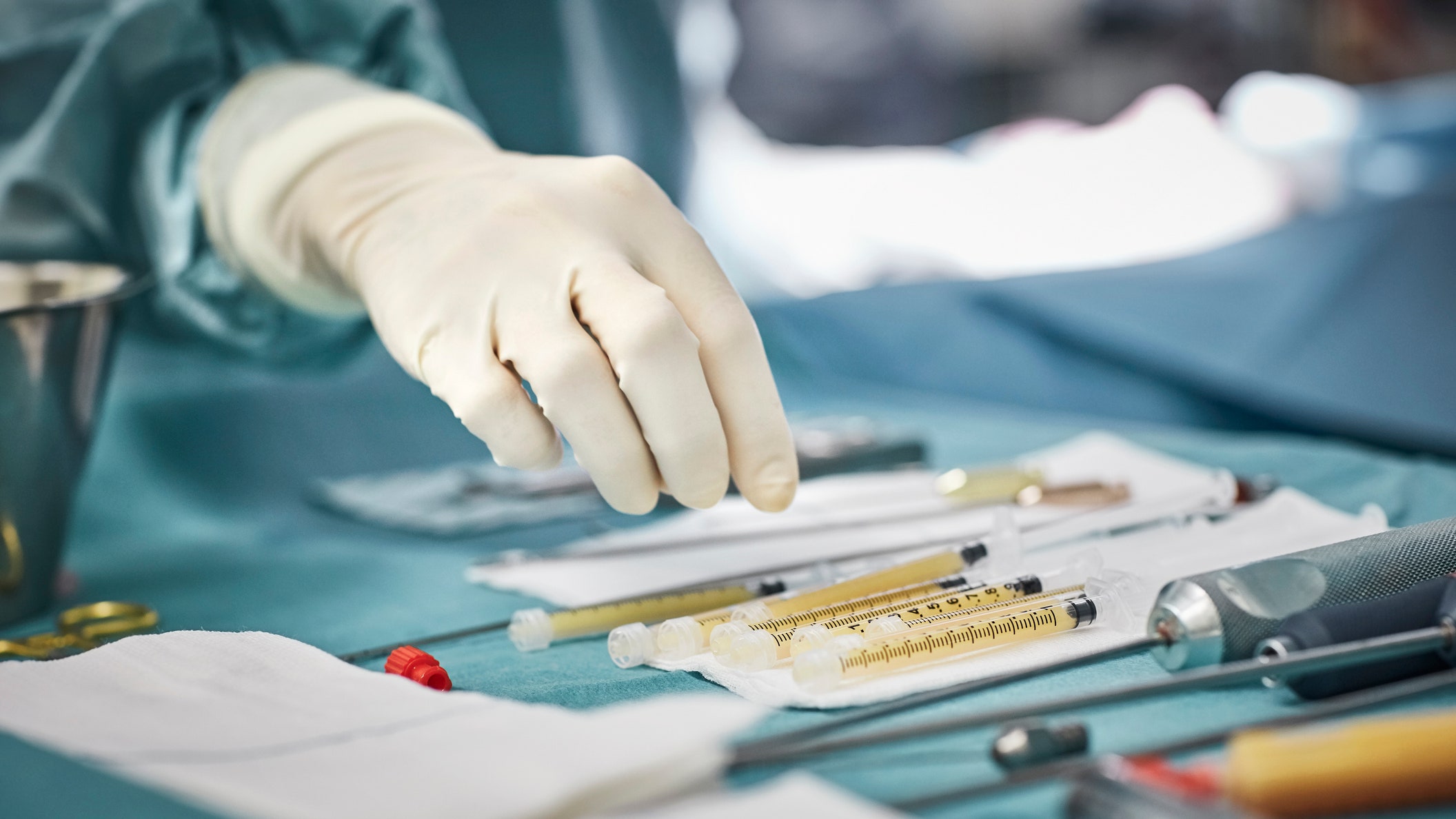 Closeup of female surgeon's hand over equipment