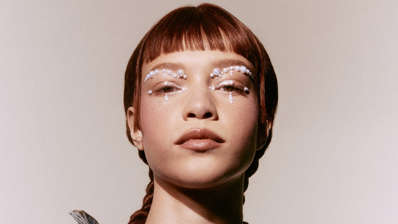 Woman with braids and pearl eye makeup