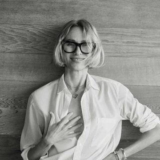 black and white photo of Naomi Watts in front of a wood background