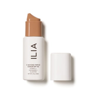 A white and mediumtan skintoned bottle of the Ilia C Beyond Triple Serum SPF 40 on a white background
