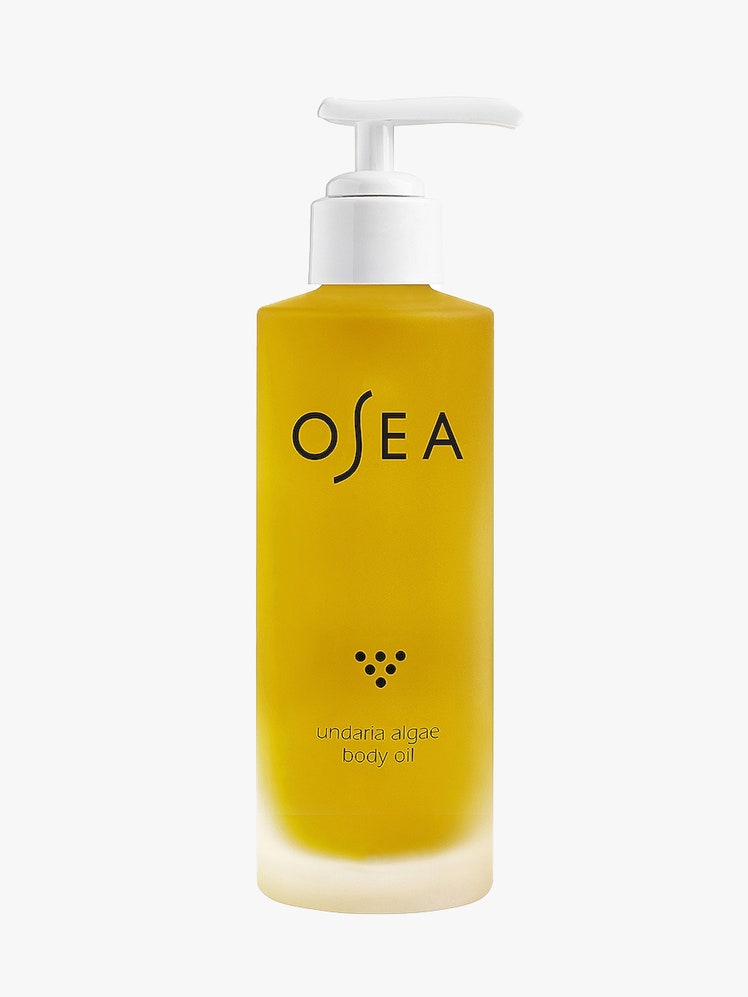 Osea Undaria Algae Body Oil bottle of gold body oil with white pump cap on light gray background