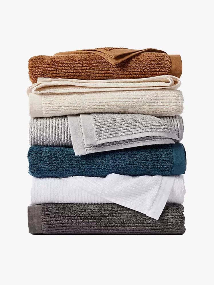 Coyuchi Temescal Organic Cotton Ribbed Bath Towel stack of folded towels in muted colors on light gray background