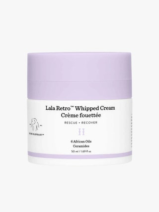 Drunk Elephant Lala Retro Whipped Moisturizer white jar with purple top on light grey background