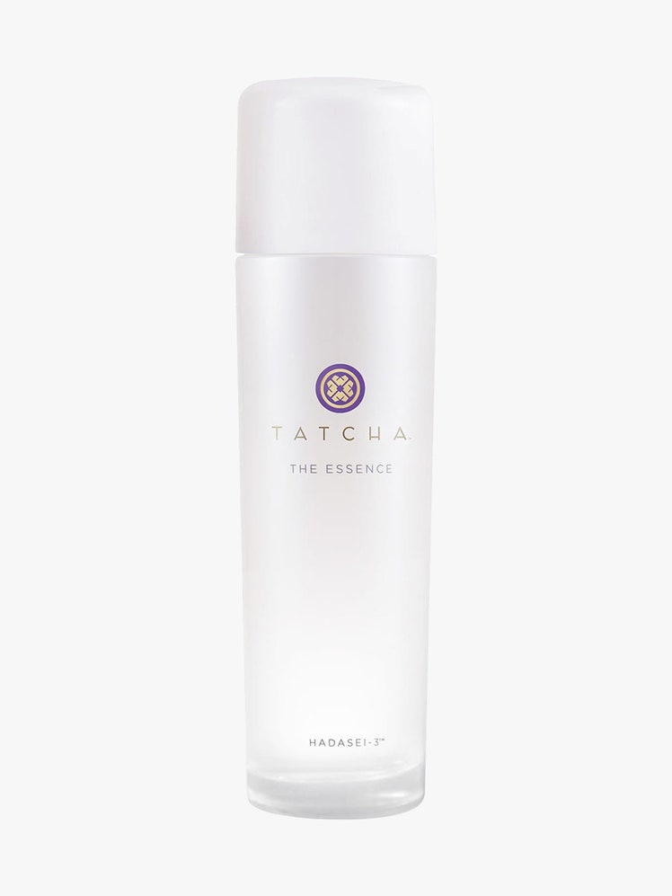 Tatcha The Essence white bottle on light gray background