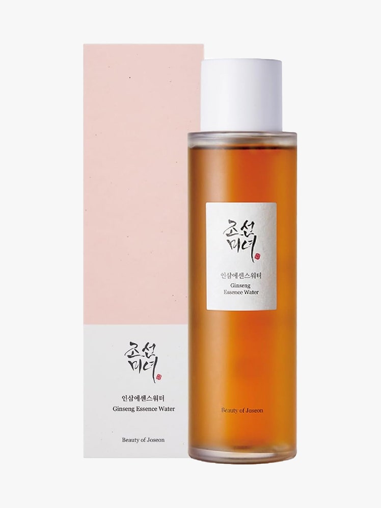 Beauty of Joseon Ginseng Essence Water bottle of orange essence with white cap and pink box next to it on light gray background