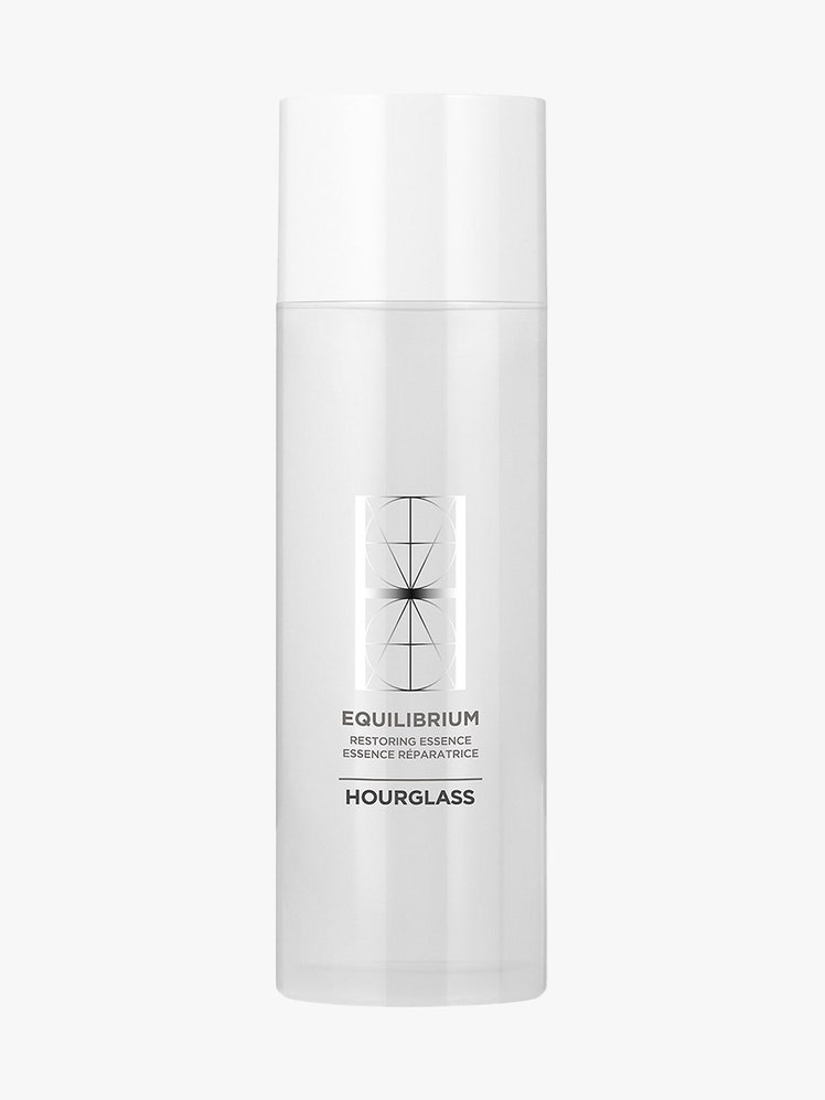 Hourglass Equilibrium Restoring Essence white bottle on light gray background