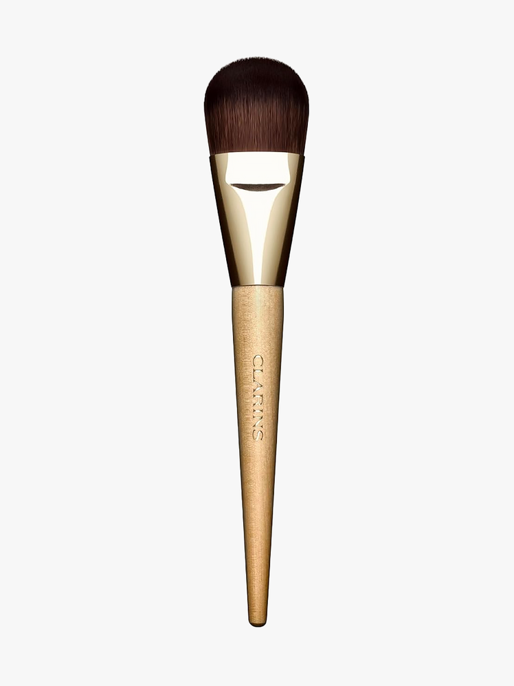 Clarins Flat Foundation Brush with wooden handle on light gray background