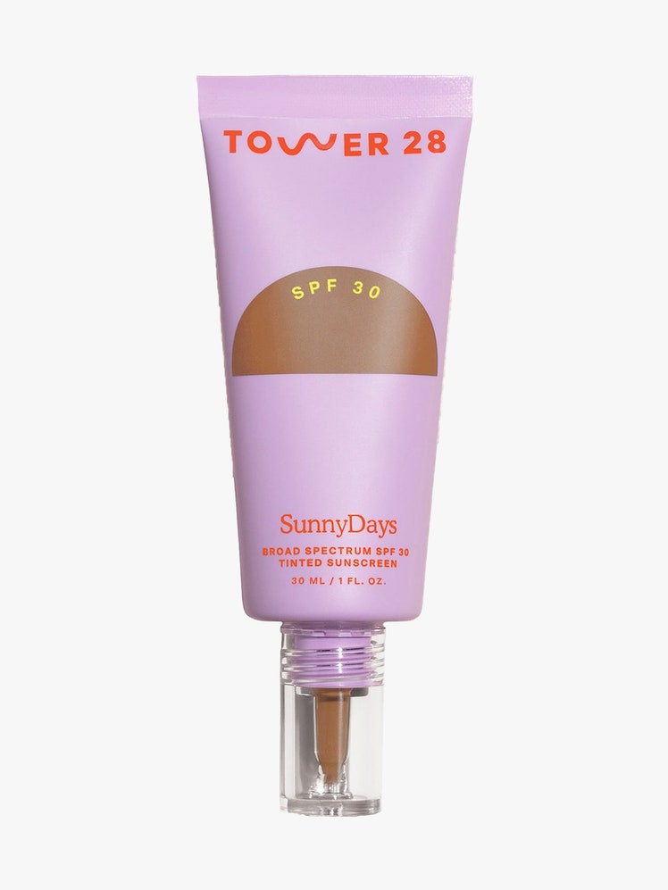 Tower 28 SunnyDays Tinted SPF Sunscreen Foundation purple tube of foundation with transparent window and pointed tip on light gray background
