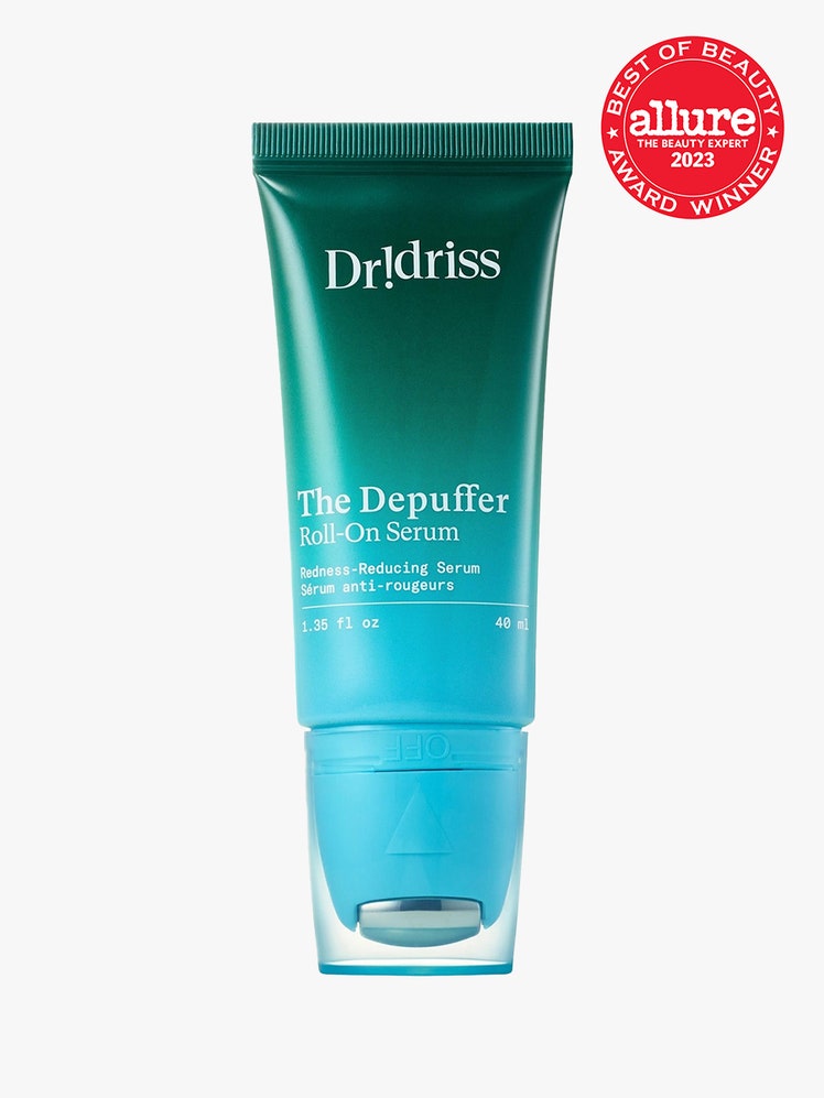 Dr. Idriss The Depuffer RollOn Serum green to blue gradient tube with roller applicator on light gray background with...